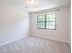 Bedroom featuring neutral carpet, one window, and a light fixture at 2090 Sand Wedge Nw Cir, Kennesaw, GA 30144