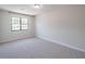 Spacious bedroom with plush gray carpet and a large window at 2090 Sand Wedge Nw Cir, Kennesaw, GA 30144
