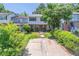 Quaint two-story townhome with a concrete driveway and landscaping, offering a serene suburban setting at 2090 Sand Wedge Nw Cir, Kennesaw, GA 30144