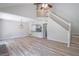 Open concept living room features wood flooring, stairs and light fixture at 2090 Sand Wedge Nw Cir, Kennesaw, GA 30144