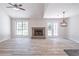 Living room features vaulted ceiling, brick fireplace, and wooden floors at 2090 Sand Wedge Nw Cir, Kennesaw, GA 30144