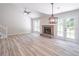 Bright living room with fireplace, wooden floors, and double doors leading to patio at 2090 Sand Wedge Nw Cir, Kennesaw, GA 30144