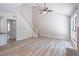 Open-concept living room with vaulted ceiling, wooden floors, and staircase at 2090 Sand Wedge Nw Cir, Kennesaw, GA 30144