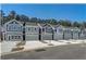 Row of gray townhomes with two-car garages and landscaped front yards on a sunny day at 5154 Longview Run, Decatur, GA 30035
