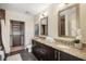 Elegant bathroom featuring dual vanities, granite countertops, and a luxurious walk-in shower at 1080 Peachtree Ne St # 2005, Atlanta, GA 30309