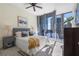 Cozy bedroom featuring modern decor, city views through large windows, and elegant furnishings at 1080 Peachtree Ne St # 2005, Atlanta, GA 30309