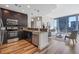 Modern kitchen featuring dark cabinets, stainless steel appliances, granite countertops, and an open living space at 1080 Peachtree Ne St # 2005, Atlanta, GA 30309