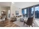Modern living area featuring a kitchen and city views through expansive windows, creating an open, airy atmosphere at 1080 Peachtree Ne St # 2005, Atlanta, GA 30309