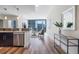 Open living space featuring a modern kitchen, inviting living room, and expansive windows with stunning city views at 1080 Peachtree Ne St # 2005, Atlanta, GA 30309