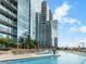 A beautifully designed pool with sun loungers for relaxation surrounded by landscaped gardens at 1080 Peachtree Ne St # 2005, Atlanta, GA 30309