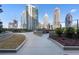 Scenic walkway surrounded by manicured landscaping and towering city views, providing a tranquil outdoor experience at 1080 Peachtree Ne St # 2005, Atlanta, GA 30309