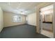 Spacious basement featuring a drop ceiling, carpeting, a window, and an adjacent bathroom at 1129 Annie Sw Ln, Mableton, GA 30126