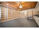Large open basement space showcasing custom shelving, built-in desk, and wood ceiling design at 1129 Annie Sw Ln, Mableton, GA 30126