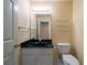 Bathroom with a vanity with black countertop and a sleek mirror, offering a modern and functional space at 1129 Annie Sw Ln, Mableton, GA 30126