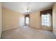 Carpeted bedroom with neutral walls, ceiling fan, and a window with curtains at 1129 Annie Sw Ln, Mableton, GA 30126