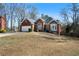 Charming brick home with a manicured lawn and an attached two-car garage at 1129 Annie Sw Ln, Mableton, GA 30126