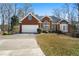 Charming single-story brick home with well-manicured lawn and attached two-car garage at 1129 Annie Sw Ln, Mableton, GA 30126