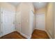 Neutral hallway with hardwood floors featuring three entry and closet doors at 1129 Annie Sw Ln, Mableton, GA 30126