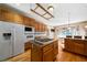 View of kitchen with cooktop island, eat-in area, wooden cabinets and modern appliances at 1129 Annie Sw Ln, Mableton, GA 30126