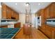Traditional kitchen boasts an island cooktop, wooden cabinets, and modern appliances at 1129 Annie Sw Ln, Mableton, GA 30126