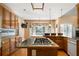 View of kitchen island with cooktop, countertops, wooden cabinets and a window at 1129 Annie Sw Ln, Mableton, GA 30126