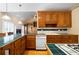 Kitchen featuring countertops, built in appliances, wooden cabinets, and a fireplace at 1129 Annie Sw Ln, Mableton, GA 30126
