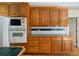 Close up of Kitchen's wooden cabinets, microwave and oven combination, and countertops at 1129 Annie Sw Ln, Mableton, GA 30126