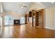 Living room boasting a brick fireplace, hardwood flooring, and built-in bookshelves at 1129 Annie Sw Ln, Mableton, GA 30126