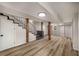 Finished basement with modern flooring, exposed beams, stairs to upper floor at 1282 Westridge Sw Rd, Atlanta, GA 30311