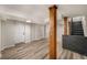 Finished basement with wood-look floors, wooden support beams, and stairs to the main level at 1282 Westridge Sw Rd, Atlanta, GA 30311