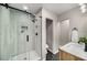 Bathroom with glass enclosed shower, wood vanity and black and white floors at 1282 Westridge Sw Rd, Atlanta, GA 30311
