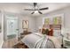 Cozy bedroom features neutral tones, ceiling fan, and an adjacent bathroom with glass shower at 1282 Westridge Sw Rd, Atlanta, GA 30311