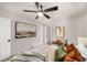 Bedroom featuring a ceiling fan, large artwork, and cozy neutral color palette at 1282 Westridge Sw Rd, Atlanta, GA 30311