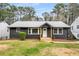 Charming home featuring a dark brick exterior, inviting front porch, and well-maintained lawn at 1282 Westridge Sw Rd, Atlanta, GA 30311