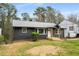 Charming home featuring a dark brick exterior, inviting front porch, and well-maintained lawn at 1282 Westridge Sw Rd, Atlanta, GA 30311