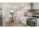 A bright, eat-in kitchen with stainless appliances, wood floors, and a view to the adjacent living room at 1282 Westridge Sw Rd, Atlanta, GA 30311