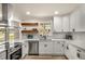 A lovely kitchen features white cabinets, stainless appliances, a window view, and stylish countertops at 1282 Westridge Sw Rd, Atlanta, GA 30311