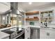 Cozy kitchen features modern stainless steel appliances, floating shelves, and a view to the open living area at 1282 Westridge Sw Rd, Atlanta, GA 30311