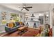Spacious living room that flows into a kitchen, featuring large windows and a comfortable seating area at 1282 Westridge Sw Rd, Atlanta, GA 30311