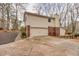 Rear view of a two-story home showing garage and outdoor deck at 1417 Hickory Sw Dr, Lilburn, GA 30047