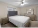 Comfortable bedroom with a tufted headboard, matching dressers, and neutral color scheme at 1417 Hickory Sw Dr, Lilburn, GA 30047