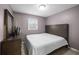 Calm bedroom with a large bed, natural light from the window, and modern dresser at 1417 Hickory Sw Dr, Lilburn, GA 30047