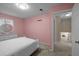 Cozy bedroom with neutral colors, a large bed, and an entryway to another room at 1417 Hickory Sw Dr, Lilburn, GA 30047