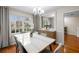 Bright dining area with a large table, perfect for gatherings, bathed in natural light from surrounding windows at 1417 Hickory Sw Dr, Lilburn, GA 30047
