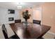 Charming dining room with dark wood table, fireplace, and view into living room at 1417 Hickory Sw Dr, Lilburn, GA 30047