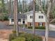 Attractive two-story home featuring neutral siding and a welcoming front porch with chairs at 1417 Hickory Sw Dr, Lilburn, GA 30047