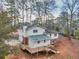 Aerial exterior view of home with multi-level deck, mature trees at 1417 Hickory Sw Dr, Lilburn, GA 30047