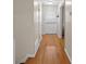 Hallway featuring lovely hard wood floors and neutral walls, with access to the front door at 1417 Hickory Sw Dr, Lilburn, GA 30047
