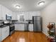 Modern kitchen with white cabinets, stainless steel appliances, and granite countertops offers an inviting space at 1417 Hickory Sw Dr, Lilburn, GA 30047