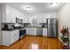 Modern kitchen with stainless steel appliances, sleek white cabinetry, and ample counter space for cooking at 1417 Hickory Sw Dr, Lilburn, GA 30047